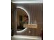 Modern living room with designer mirror, lighted accent wall, and decor at 2069 Canton Park Dr, Winter Haven, FL 33881