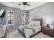Spacious bedroom with a king-size bed, two windows, and neutral decor at 4150 Sunset Preserve Blvd, Orlando, FL 32820