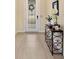 Bright entryway with wood console table and neutral tile flooring at 4150 Sunset Preserve Blvd, Orlando, FL 32820