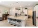 Modern kitchen with white cabinets, large island, and stainless steel appliances at 4150 Sunset Preserve Blvd, Orlando, FL 32820