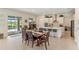 Open kitchen and dining area with pool view at 4150 Sunset Preserve Blvd, Orlando, FL 32820