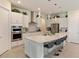 Modern kitchen boasting white cabinets, quartz countertops, and island at 4150 Sunset Preserve Blvd, Orlando, FL 32820