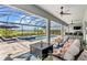 Covered patio with seating area and fire pit adjacent to the pool at 4150 Sunset Preserve Blvd, Orlando, FL 32820
