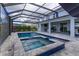 L-shaped pool and spa with a covered patio and privacy screens at 4150 Sunset Preserve Blvd, Orlando, FL 32820