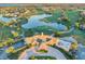 Aerial view of a golf course community featuring a clubhouse, lake, and meticulously manicured greens at 10852 Mobberley Cir, Orlando, FL 32832