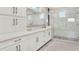 Bathroom with white cabinets, double sinks, white marble countertops, and a spacious glass-enclosed shower at 10852 Mobberley Cir, Orlando, FL 32832
