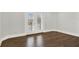 Bedroom with hardwood floors and French doors offering access to the outdoor balcony at 10852 Mobberley Cir, Orlando, FL 32832