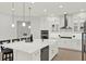 Bright, modern kitchen with white cabinetry, stainless steel appliances, and a spacious center island at 10852 Mobberley Cir, Orlando, FL 32832