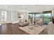 Bright living room featuring modern furnishings and a sliding glass door to an outdoor balcony at 10852 Mobberley Cir, Orlando, FL 32832