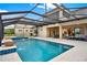 Enjoy outdoor living with a screened-in pool and spa overlooking a beautifully landscaped yard at 10852 Mobberley Cir, Orlando, FL 32832