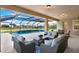 An inviting screened-in pool area with comfortable wicker seating and a view of the lush backyard at 10852 Mobberley Cir, Orlando, FL 32832