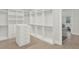 Spacious walk-in closet providing ample storage with built-in shelves and drawers at 10852 Mobberley Cir, Orlando, FL 32832