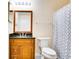 Traditional bathroom featuring a wood vanity cabinet with a black countertop and a shower with a geometric curtain at 2053 Dixie Belle Dr # 2053C, Orlando, FL 32812