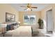 Comfortable bedroom with a large window, ceiling fan, and stylish decor at 2053 Dixie Belle Dr # 2053C, Orlando, FL 32812