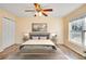 Cozy bedroom featuring a large window, ceiling fan, and ample closet space at 2053 Dixie Belle Dr # 2053C, Orlando, FL 32812