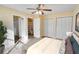 Spacious bedroom featuring multiple closets, a ceiling fan, and a glimpse into an en-suite bathroom at 2053 Dixie Belle Dr # 2053C, Orlando, FL 32812