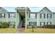 Inviting two-story condo with a handicap parking sign, black shutters, and well-maintained landscaping at 2053 Dixie Belle Dr # 2053C, Orlando, FL 32812
