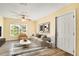 Bright living room with modern decor, a beige sofa, and a large window with natural light at 2053 Dixie Belle Dr # 2053C, Orlando, FL 32812