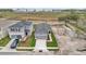 An aerial view of two homes in a residential neighborhood showcasing landscaping at 219 Ash Way, Auburndale, FL 33823