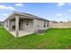 Well-maintained backyard includes a covered patio and lush green lawn at 219 Ash Way, Auburndale, FL 33823