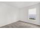 Bright bedroom featuring neutral carpet, a large window, and fresh white walls at 219 Ash Way, Auburndale, FL 33823