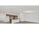 Open-concept kitchen features granite counters, stainless appliances, and center island at 219 Ash Way, Auburndale, FL 33823