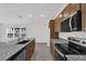 Modern kitchen showcasing a stainless steel sink, island with granite countertops, and appliances at 219 Ash Way, Auburndale, FL 33823