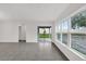 Open living area featuring tile floors, bright windows, and a sliding glass door to the patio at 219 Ash Way, Auburndale, FL 33823
