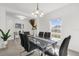 Spacious dining room featuring a glass-top table, black chairs, and a large window at 236 Denali St, Haines City, FL 33844