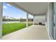 A covered back porch overlooks a large pond and green backyard at 528 Carya Way, Auburndale, FL 33823