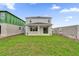 A spacious backyard with new grass, a covered patio, and construction nearby offers potential at 528 Carya Way, Auburndale, FL 33823