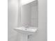 Bathroom pedestal sink with large mirror and modern fixtures enhance this home's design at 528 Carya Way, Auburndale, FL 33823