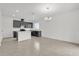 Open-concept kitchen features dark cabinets, an island with a countertop, and tile flooring at 528 Carya Way, Auburndale, FL 33823