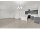 Spacious kitchen area with tile flooring, complete with a modern island and stylish chandelier at 528 Carya Way, Auburndale, FL 33823
