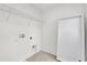 A laundry room with tile floors, wire shelving and hookups provide convenience and storage at 528 Carya Way, Auburndale, FL 33823
