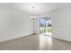 Bright living room with tile floors, chandelier, and sliding doors at 528 Carya Way, Auburndale, FL 33823