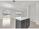 Open-concept living space featuring an island and sliding doors leading to the backyard at 528 Carya Way, Auburndale, FL 33823