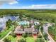 Aerial view of community pool, clubhouse, and surrounding landscape at 8622 Dufferin Ln, Orlando, FL 32832