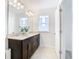 Bathroom with double vanity and large mirror, offering great storage at 8622 Dufferin Ln, Orlando, FL 32832