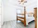 Main bedroom with wood post bed and large window at 8622 Dufferin Ln, Orlando, FL 32832