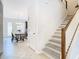 View of the entryway with staircase and a glimpse of the dining area and kitchen at 8622 Dufferin Ln, Orlando, FL 32832