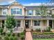 Two-story townhome with teal shutters, brick walkway, and landscaping at 8622 Dufferin Ln, Orlando, FL 32832