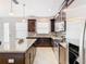 Modern kitchen with dark wood cabinets, granite countertops and island at 8622 Dufferin Ln, Orlando, FL 32832