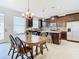 Modern kitchen with dark wood cabinets, granite countertops, and a breakfast table at 8622 Dufferin Ln, Orlando, FL 32832