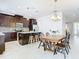 Modern kitchen with dark wood cabinets, granite countertops, and a breakfast table at 8622 Dufferin Ln, Orlando, FL 32832