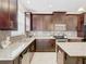 Modern kitchen with dark wood cabinets and granite countertops at 8622 Dufferin Ln, Orlando, FL 32832