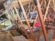 Unfinished attic with wooden support beams and storage shelves at 956 Bucksaw Pl, Longwood, FL 32750