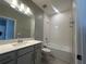 Well-lit bathroom featuring a vanity, sink, and tiled shower/tub combination at 5298 Teirgarten St, St Cloud, FL 34771