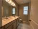 Bathroom featuring double sinks, a large mirror, and a window for natural light at 5298 Teirgarten St, St Cloud, FL 34771