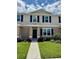 Charming two-story townhome featuring blue shutters, a well-manicured lawn, and a welcoming walkway to the front door at 6102 Galloping Dr, Apopka, FL 32712